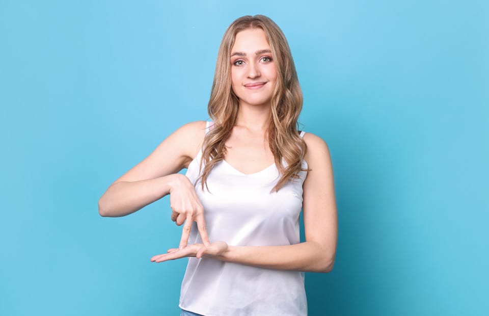Une jeune femme pratique la langue des signes