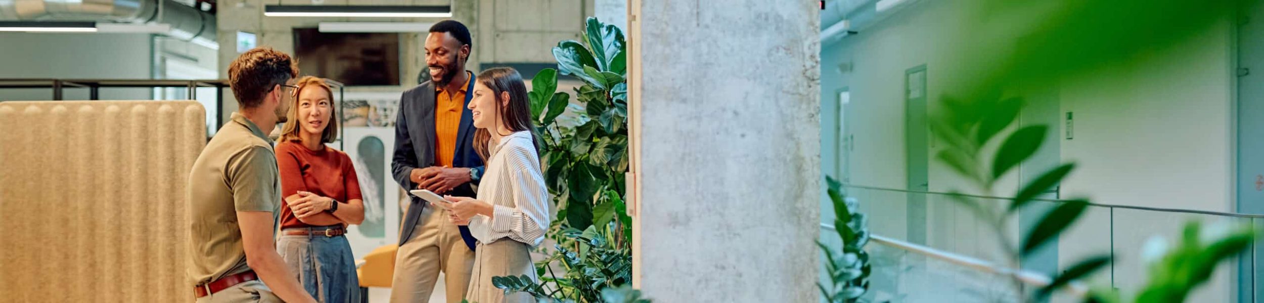 Businesspeople discussing in modern green office with plants