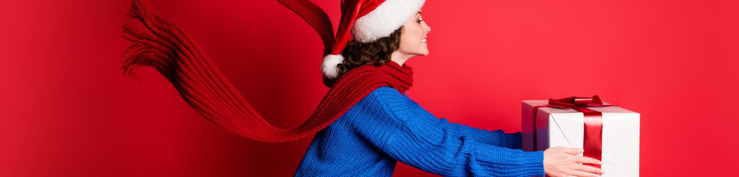 Profile side view portrait of her she attractive pretty cheerful girl wearing, festal look holding in hands giving large bid romantic giftbox isolated bright vivid shine vibrant red color background